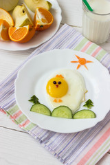 Creative idea for kid breakfast – chick from scrambled eggs and vegetables on a white background free space for text