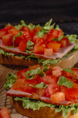Italian tomato bruschetta with chopped vegetables, herbs and oil on grilled or toasted crusty ciabatta bread