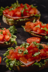 Italian tomato bruschetta with chopped vegetables, herbs and oil on grilled or toasted crusty ciabatta bread