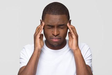 Stressed young african american man feel pain having terrible strong headache concept, tired upset...