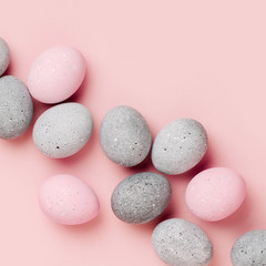 Stylish background of pale pink and gray Easter eggs. Dyed Easter eggs. Flat lay
