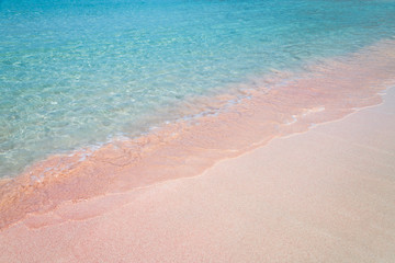 Fototapeta na wymiar Pink sand and turquoise pristine water one Balos beach in Crete, Greece