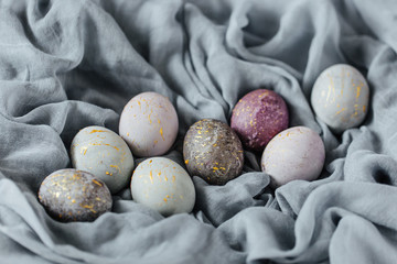 Obraz premium Stylish gray, violet and blue Easter eggs. Homemade naturally dyed Easter eggs