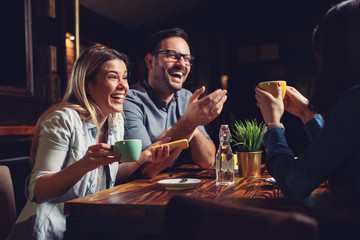 Beautiful happy friends enjoying their afternoon coffee - Image