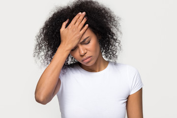 Upset young african woman touching forehead feeling headache hurt, sad ill black girl frustrated...