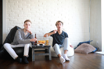 Football fans watch the match and drink beer