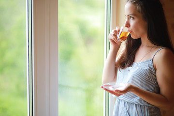 A girl at the window in the house