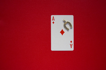  Ace of Diamonds on  a red background with a horseshoe.  good luck and fortune concept