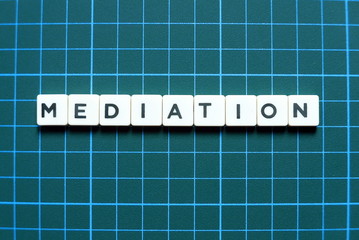 Business and finance concept. Mediation letter on green background.