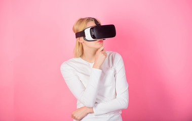 Young woman using a virtual reality headset. Happy woman exploring augmented world, interacting with digital interface. Excited smiling businesswoman wearing virtual reality glasses.