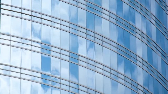 Blue sky and clouds reflected in structural  modular glass wall time lapse