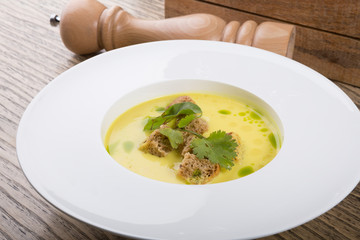 Yellow cream soup served with croutons
