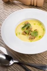 Yellow cream soup served with croutons