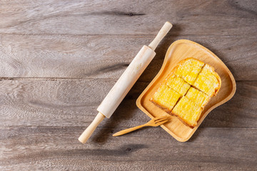 Butter spread on sliced healthy grain bread, top view