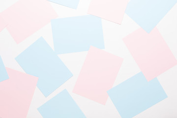 Abstract geometric background in light pastel tones from sheets of thick pale past paper.