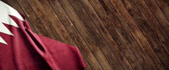 Qatar, cloth flag on wood