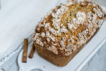 Banana Bread with cinnamon crumb coat on white wooden background close up selective focus