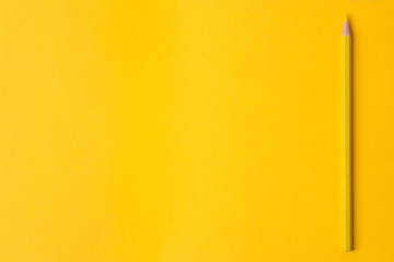 Composition with a yellow pencil on a bright trendy yellow background. top view. space for text