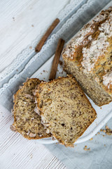 Banana Bread with cinnamon crumb coat on white wooden background close up selective focus