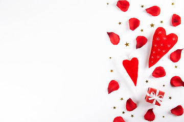 Romantic happy valentines day greeting card, wedding invitation, women's day concept. white background covered with deep red, scarlet, crimson rose petals. Close up, top view, copy space, mock up.