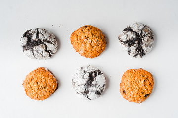 minimalism chocolate brownies and  oat cookies isolated on white background in order 