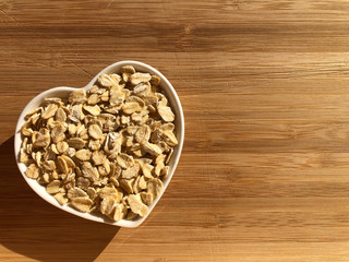 rolled oats in a heart shaped bowl