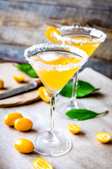 cocktail with kumquat on wooden background
