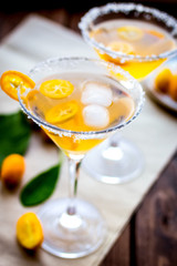 cocktail with kumquat on wooden background