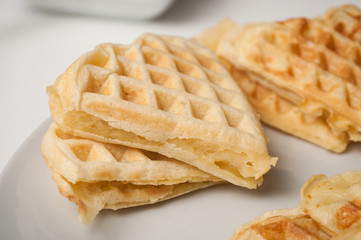 closeup of waffle in shaped heart in a white plate