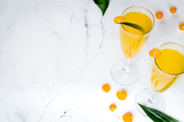 cocktail with physalis in glass on stone background
