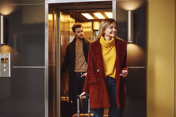 Lovely vacation. Young couple enter to the hotel floor together