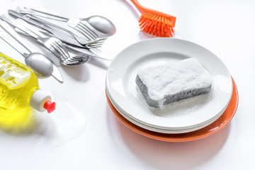concept of washing dishes on white background top view