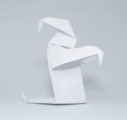 Photo of white origami ghost isolated on white background