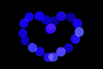 blue color heart. abstract bokeh background. heart shaped lights.