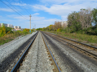 Fototapeta na wymiar Railroad rails converge on the horizon