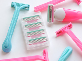 Removal of unwanted hair. top view. Concept of using razor. Shaving razor instrument. Skin care concept. Epilation hair removal. Flat lay, top view.multi-colored women's shaving razors isolated.