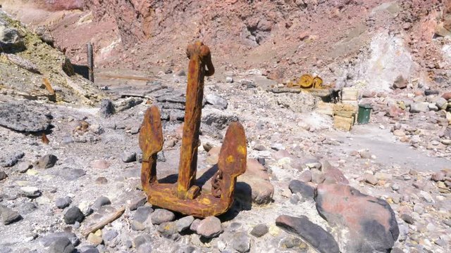 Handheld shot of corroded anchor at abandoned sulphur mine on White Island in New Zealand