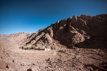 Oasis in the mountains on the background of a beautiful sunrise