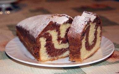 Homemade chocolate cake on a plate, marble texture, close-up view