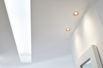 Two spot light illuminated on white ceiling