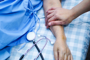 Touching hands Asian senior or elderly old lady woman patient with love, care, helping, encourage...