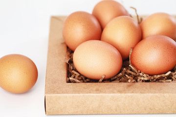 Chicken brown eggs on a white table