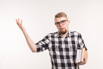 Education, emotions, geek and nerd concept - man in glasses and books looks like he is perplexed