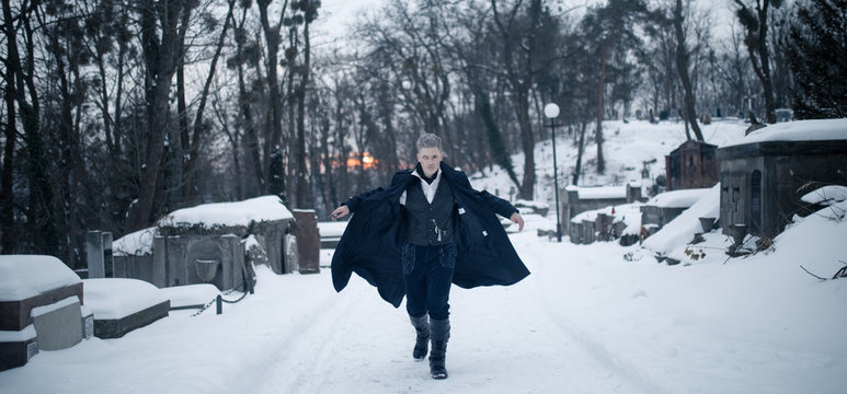 Young man in image of black magician runs.