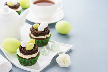 Easter chocolate cupcakes decorated with nest and candy eggs.