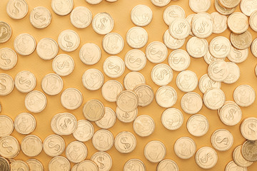top view of golden coins with dollar signs isolated on orange, st patrick day concept