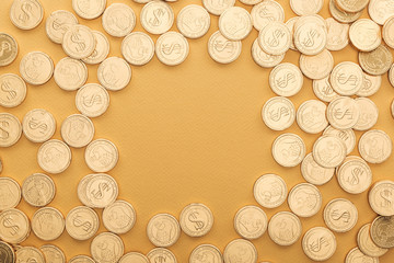 top view of golden coins with dollar signs isolated on orange with copy space, st patrick day concept