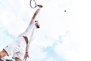 Stay focused. Tennis player is looking at the ball in the air