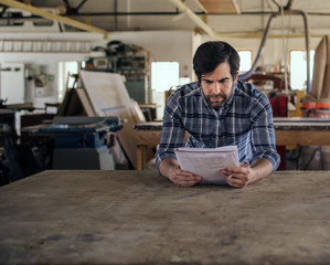 Entrepreneur creating a new design in his furniture workshop