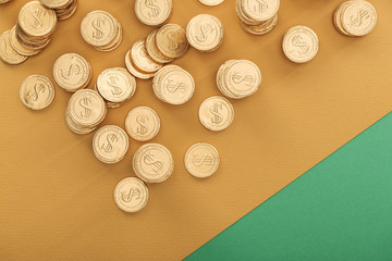 top view of golden coins with dollar signs on green and orange background, st patrick day concept